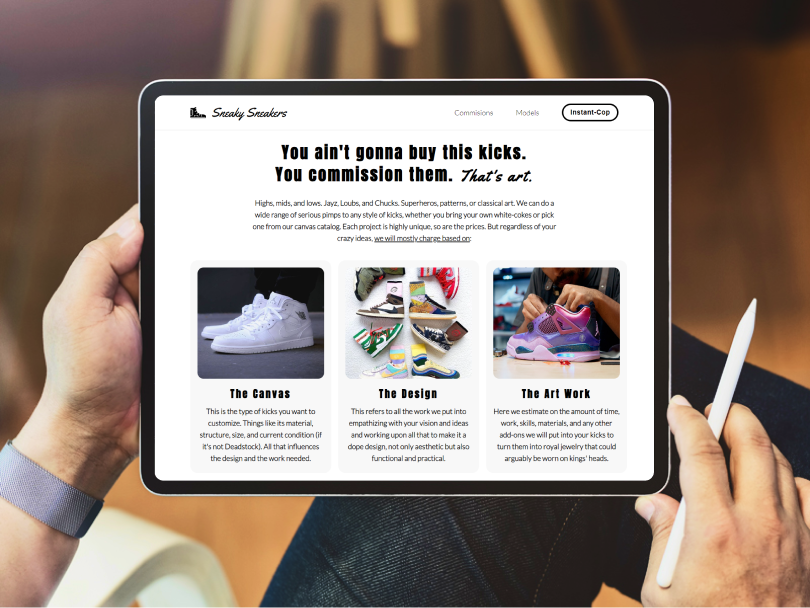 Hands holding a tablet with a web design